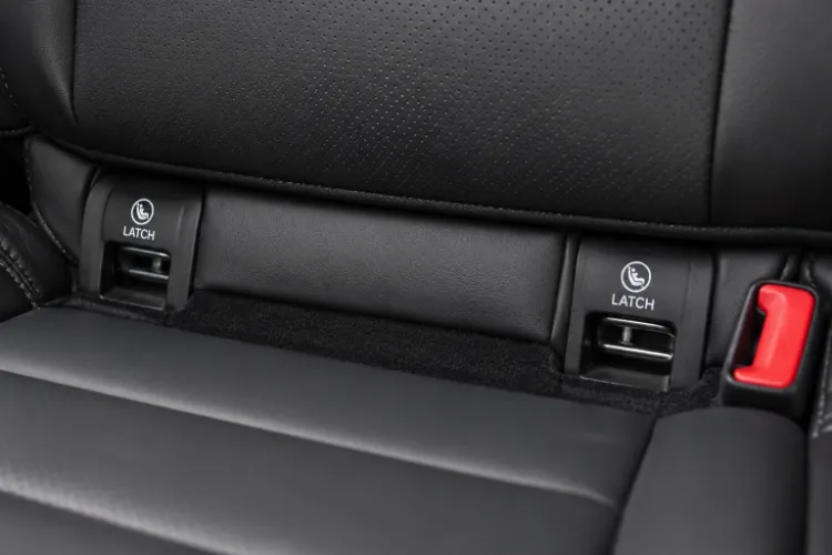 Close-up of LATCH lower anchor point in a vehicle's back seat